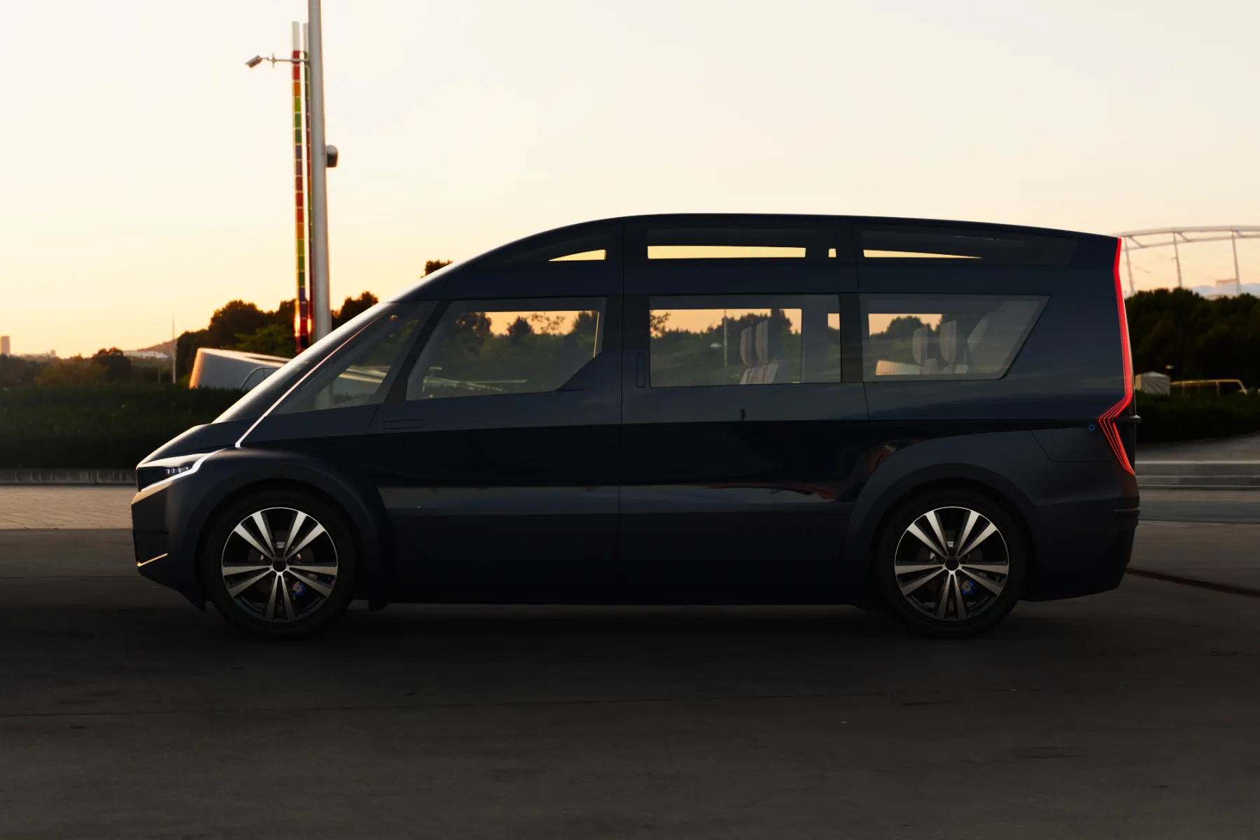 Side profile of Indigo Flow Ride, a lightweight and efficient electric vehicle, designed for urban ride-hailing services at sunset